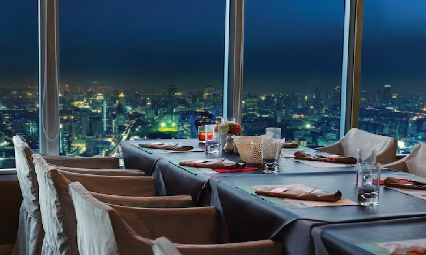 Table setting in arestaurant with a view of the city at night